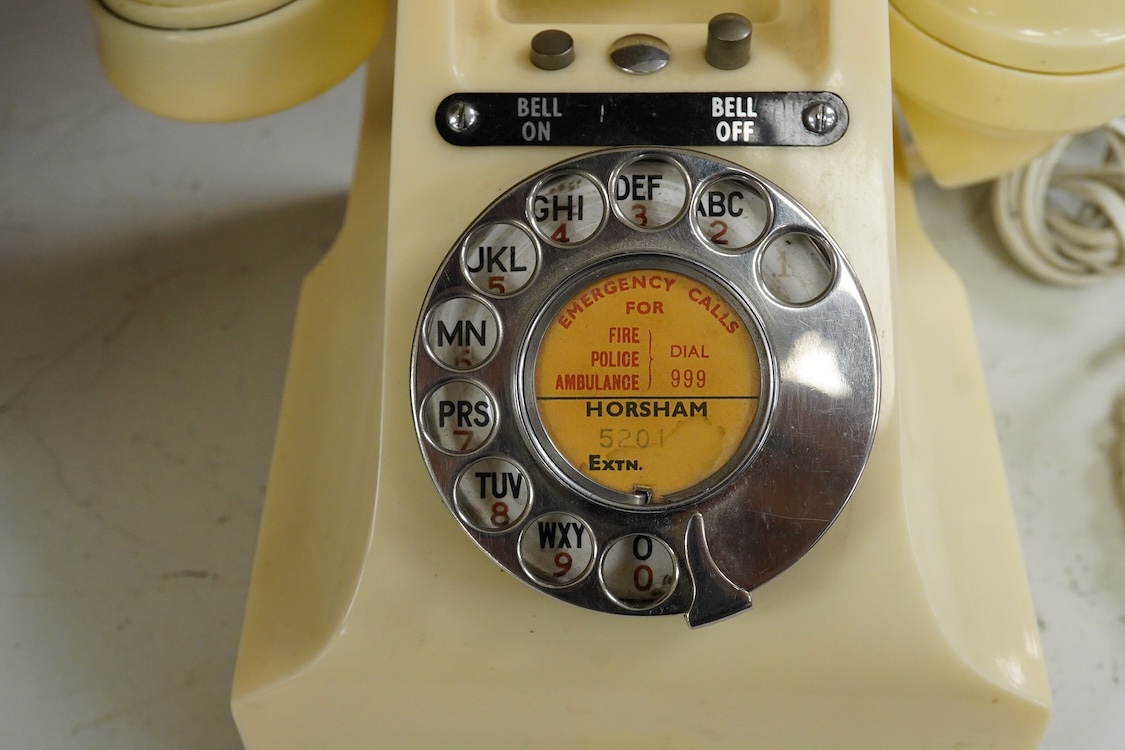 A GPO telephone model 312 in ivory, with a paper centre for a Horsham telephone number, the handset moulded with 164 56 under the grip, with some restoration and adaptations